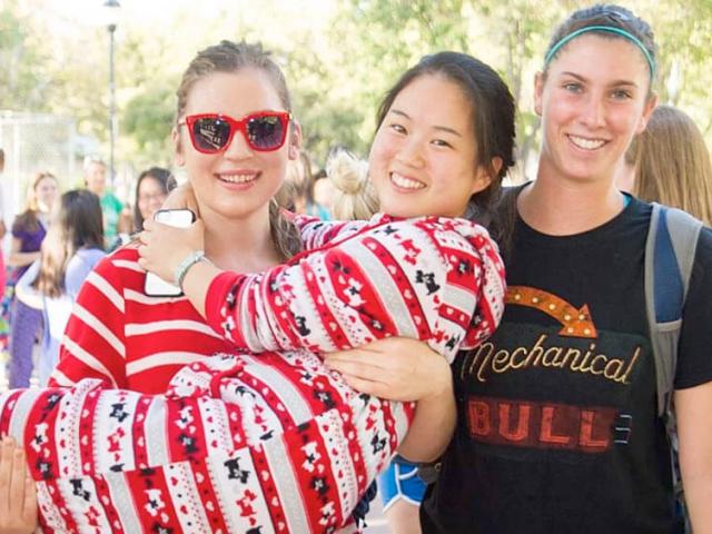 Three UC Davis students pose in for a picture at the Davis Train station in their pajams!